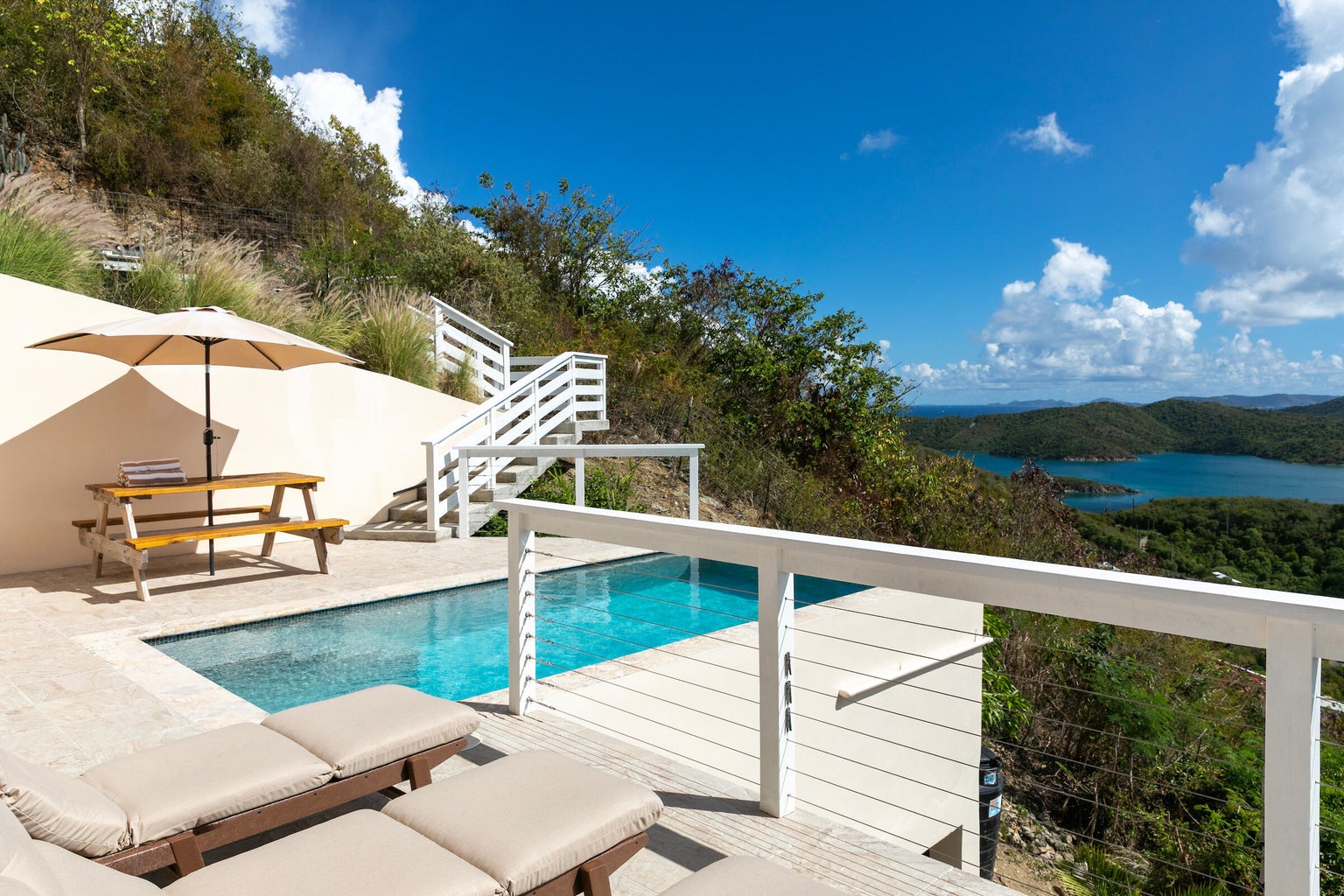 Pool terrace and loungers above the hills
